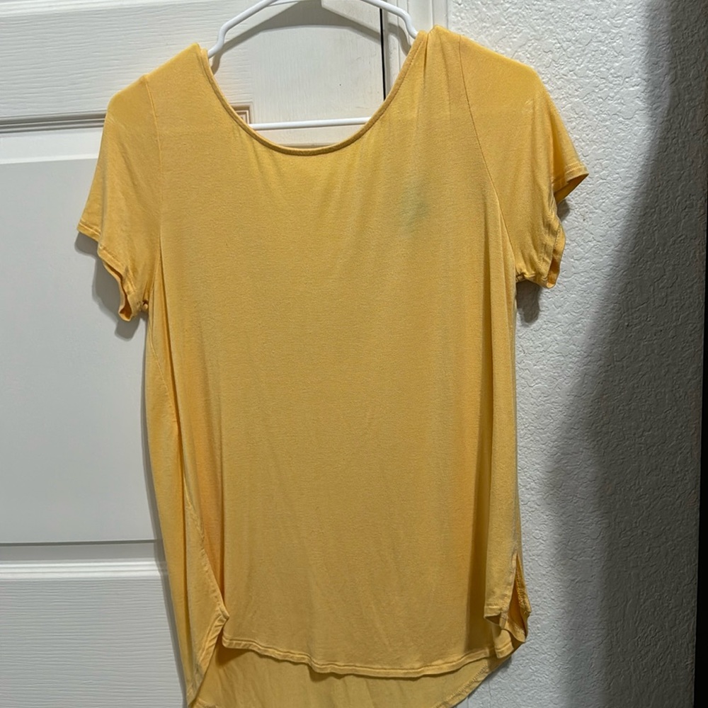 Yellow t shirt, with cute design in the back. Size small